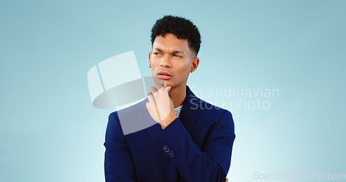 Image of Man, thinking with idea in studio or decision and planning problem solving by blue background. Young, brazil and person in thought for creative solution, project insight and choice by mock up space