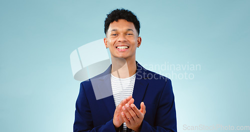 Image of Man, portrait and clapping hands or celebration studio or business growth, winning or opportunity. Male person, face and applause on blue background as mockup or achievement, congratulations or pride