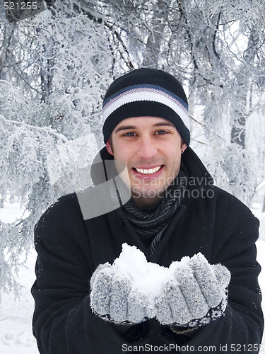 Image of Smiling man holding snow