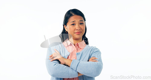 Image of Portrait, attitude and an asian woman arms crossed in studio isolated on a white background for rejection. Angry, frustrated or deny with an unhappy young person looking moody, negative or annoyed