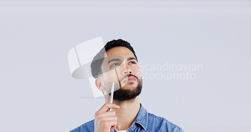 Image of Thinking, face and man with pen in studio looking up at mockup for brainstorming on grey background. Idea, questions and model with problem solving, planning or emoji for solution, guess or choice
