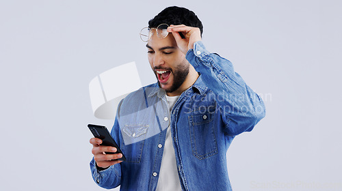 Image of Man, smartphone and excited with winner notification with surprise on technology, reward offer and white background. Young person, wow and digital news on cellphone, announcement and mockup space