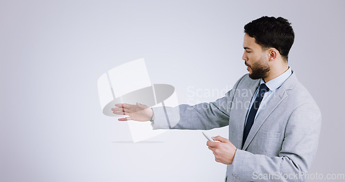 Image of Business, presentation and space with a man training in studio on a gray background for marketing. Our vision, remote and information with a serious young corporate employee on mockup for advertising