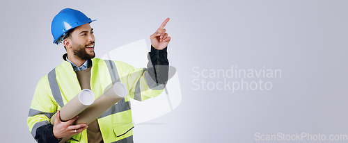 Image of Smile, pointing and man engineer with blueprint in studio with mockup space for advertising. Happy, marketing and male industrial worker with architect design and show hand gesture by gray background