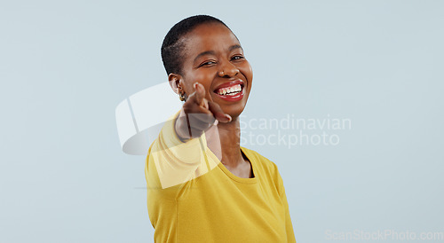 Image of Happy black woman, portrait and pointing to you for choice or selection against a gray studio background. Face of African female person or model smile with finger for decision, or choosing on mockup