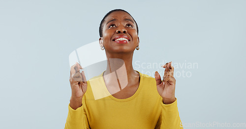 Image of Hope, wish and black woman in studio with fingers crossed for opportunity, deal or good news prayer. Praying hands, thinking and person with winning dream, confidence and faith on white background.