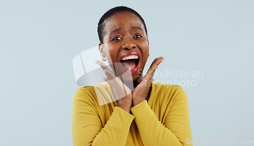 Image of Happy black woman, portrait and face in surprise for winning, prize or celebration against a studio background. Excited African female person in wow, shock or bonus promotion on sale discount or deal