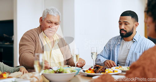 Image of Food, holidays and a family at the dinner table of their home together for eating a celebration meal. Love, thanksgiving and a group of people in an apartment for festive health, diet or nutrition