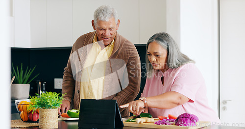 Image of Senior, couple and cooking in kitchen with tablet for dinner, lunch or vegetables with support, help and love. Elderly, man and woman with watching, peace and nutrition for bonding or relationship