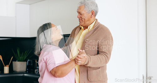 Image of Senior couple, dancing and happy in kitchen, love and house for fun, touch and romantic. Retirement, bonding together and smile for husband, wife and quality time with tango, retired and elderly