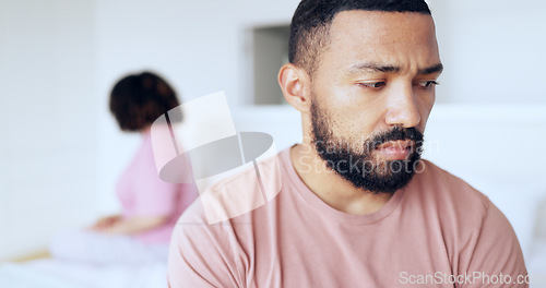 Image of Face, divorce and breakup with a man on the bed in his home after fighting with his wife as a couple. Thinking, sad or conflict with a husband in the bedroom of an apartment looking depressed