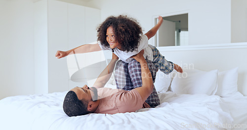 Image of Dad, daughter and airplane on bed with playing, bonding and freedom for happiness or trust in bedroom of home. Family, man and girl child with lifting in knees with balance, relationship and love