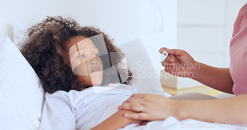 Image of Sick, thermometer or a girl with a fever in bed to relax or recover and a parent in the home to care or check. Family, kids and an unhealthy female child in the bedroom of an apartment with a fever