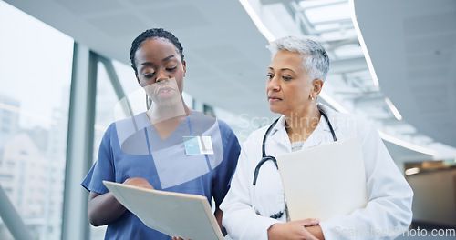 Image of Doctor, healthcare report and nurse with discussion for collaboration, hospital and assessment by medical results. Women, specialist and young medic with patient information, diversity and teamwork