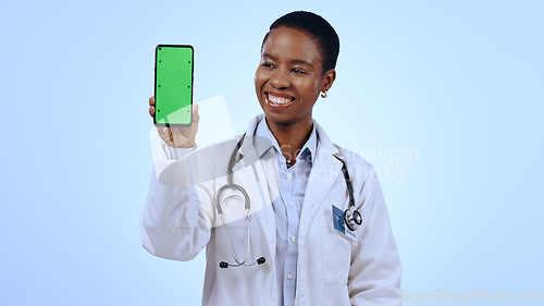 Image of Green screen, black woman and doctor with a cellphone, healthcare or professional on blue background. African person, medical or physician with smartphone, tracking markers or promotion with medicare