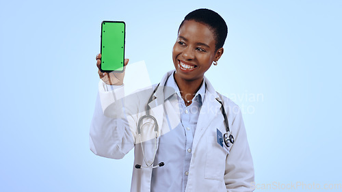Image of Green screen, black woman and doctor with a smartphone, smile and healthcare on blue background. African person, medical or professional with a cellphone, tracking markers and promotion with medicare