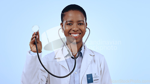Image of Happy woman, doctor and stethoscope for healthcare in studio of blue background for mock up in medicine. Portrait, black person and medical professional with smile for wellness, lungs and breathing