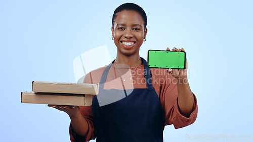 Image of Black woman, food delivery and smartphone with smile, portrait and chromakey on blue studio background. Waitress, technology and online for order, communication and worker for pizza, apron or service