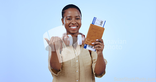 Image of Happy woman, smile and ticket for flight in studio with mock up for travel on blue background with passport. Portrait, black person and excited with hand for invite with deal, discount and vacation