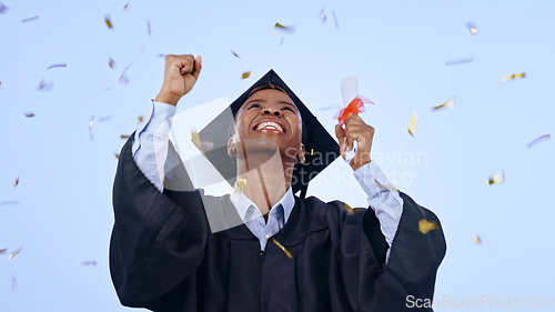 Image of Graduation, woman student and confetti celebration, success and achievement of college or university in studio. Excited African graduate with award, diploma and yes for education on a blue background