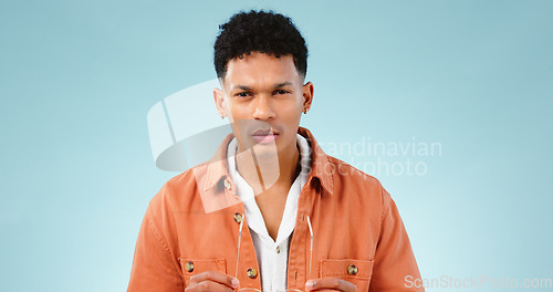 Image of Man, confused and portrait in studio with thinking mindset, doubt and problem with choice in mockup. Young person, brazilian and unsure face with question, idea error and decision by blue background