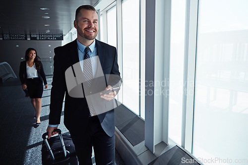 Image of Business man, smartphone and travel by airport window for reading, thinking and contact in corridor with smile. Entrepreneur, luggage and phone for flight schedule and global immigration in London