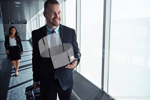 Image of Business man, woman and phone by airport window for vision, thinking and contact in corridor with smile. Entrepreneur, suitcase and smartphone with flight schedule for global immigration in London