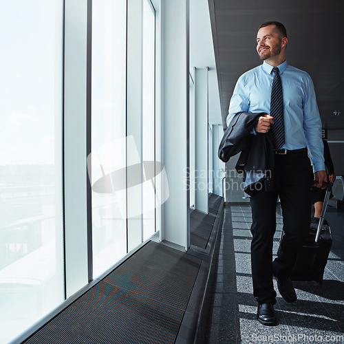 Image of Walking, thinking or happy businessman in airport for a company trip with suitcase or luggage for commute. Smile, window or corporate workers in lobby for travel or journey on international flight