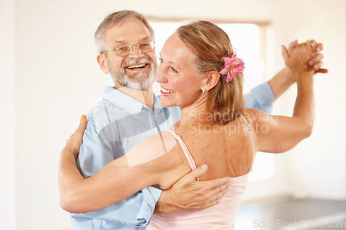 Image of Senior couple, dancing and happiness in home, love and ballroom for fun, touch and romantic. Retirement, bonding together and smile for husband, wife and quality time with tango, retired or elderly