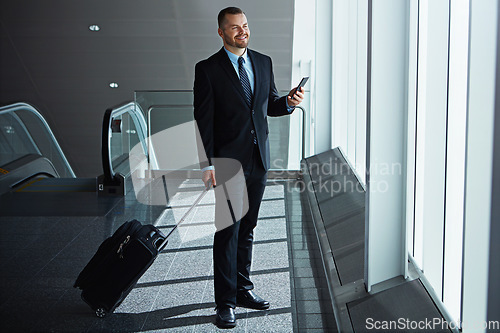 Image of Smile, thinking or businessman in airport with phone, luggage or suitcase waiting to travel. Social media, happy entrepreneur or corporate worker texting to chat on mobile app on international flight