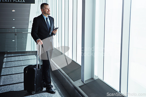 Image of Business man, phone and airport window with suitcase for smile, thinking and idea for international travel. Entrepreneur, luggage and smartphone with flight schedule for global immigration in London