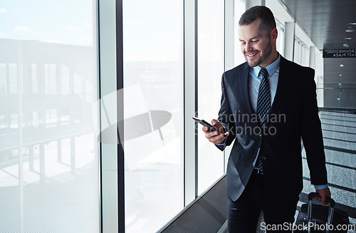 Image of Business man, cellphone and window in airport hallway for reading, thinking or vision on international travel. Entrepreneur, luggage and smartphone for flight schedule or global immigration in London