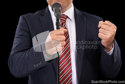 Image of Microphone, speech and hands of business man on black background for presentation, speaker and seminar. Leader, public speaking and person talking for conference, tradeshow or communication in studio