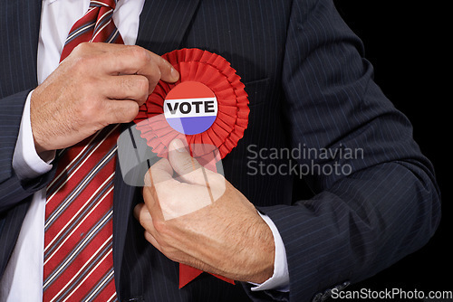 Image of Man, vote and suit for election, ribbon and politician for support and on dark studio background. Politics, voter choice and representative for party, registration and democracy for voting register