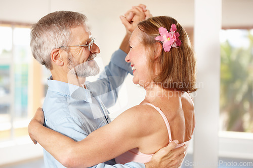 Image of Senior couple, dancing and happy in house, love and ballroom for fun, touch and romantic. Retirement, bonding together and smile for husband, wife and flower with tango, retired or elderly people