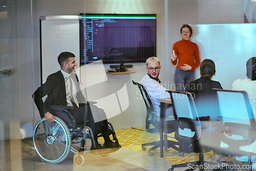 Image of A pregnant business woman with orange hair confidently presents her business plan to colleagues in a modern glass office, embodying entrepreneurship and innovation