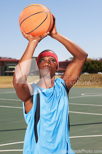 Image of Basketball, player and shoot on outdoor court for fitness challenge or sports train for game, match as athlete. Black man, score point for summer goal dunk or competition winner, cardio or confident