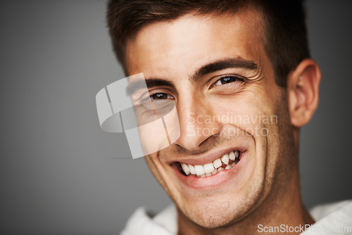Image of Portrait, smile of man and student in studio isolated on a gray background mockup space. Face, happy young person and model with positive facial expression, excited and cheerful in Spain at college