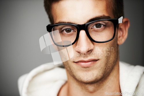 Image of Closeup, portrait and man with glasses in studio for eye care mock up on gray background in Spain. Male model, person and vision with facial expression for spectacles by correction, lens or sight