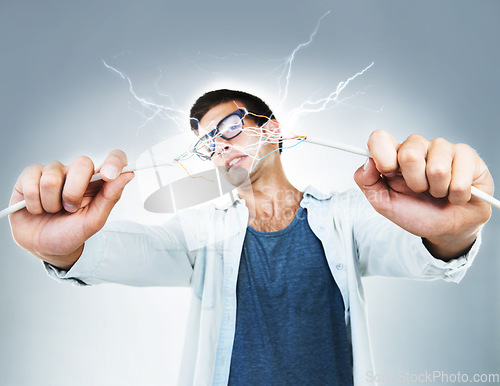 Image of Man, holding and wire for power in studio for electric engineering mockup on gray background. Portrait, male model or technician for cable by fixing, repair and technology for glitch on web in Spain