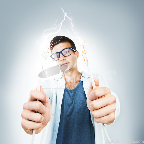 Image of Man, glasses and wires for cable in studio for electricity, spark or danger mockup on gray background. Portrait, technician or electrician by career for fixing, glitch or 404 on internet, web or app