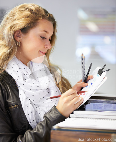 Image of Artist, student or woman with paper, pencil or schedule in design school for exam, assignment or drawing. Smile, happy or person sketching creative brief, idea or planning color inspiration in studio