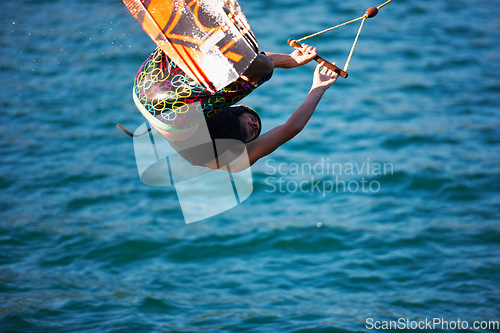 Image of Man, wakeboarding and ocean with jump, sport and fitness with speed on vacation in summer sunshine. Person, athlete and ski with rope for safety on lake, sea or river with training, exercise or waves