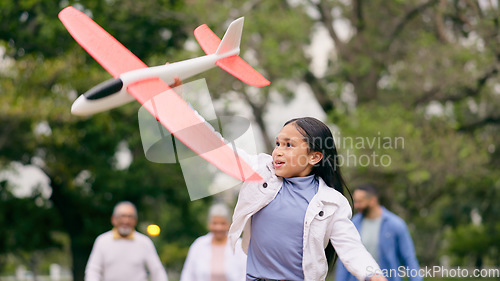Image of Outdoor, family and girl with an airplane, playing and child in park with parents for holiday, adventure and weekend outdoors with joy. Happy, group or kid with plane, mom or dad in nature with a toy