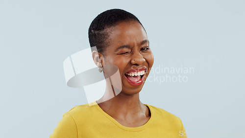 Image of Portrait, black woman with smile and wink in studio for like, opportunity or deal agreement gesture. Flirt emoji, romantic offer and face of girl with confidence, pride and secret on white background