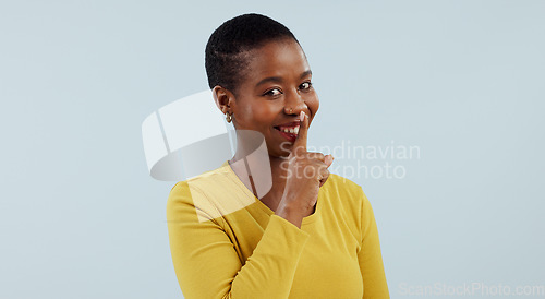 Image of Secret, portrait and happy black woman with finger on lips in studio for privacy, news or announcement on grey background. Gossip, whisper or model face with confidential hand, emoji or quiet gesture