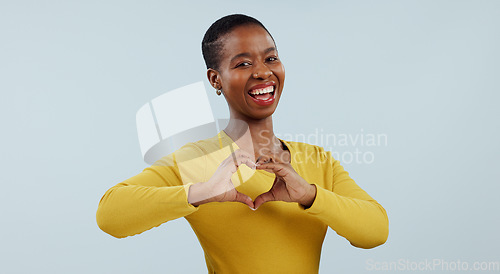Image of Happy black woman, portrait and heart hands for love, care or romance against a gray studio background. Face of African female person or model showing like emoji, shape or romantic gesture on mockup