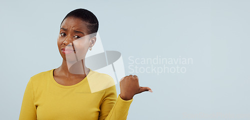 Image of Disappointed, pointing and portrait of black woman in studio with why, question and doubt. Emoji, what and face of person with hand gesture for announcement, information and news on blue background