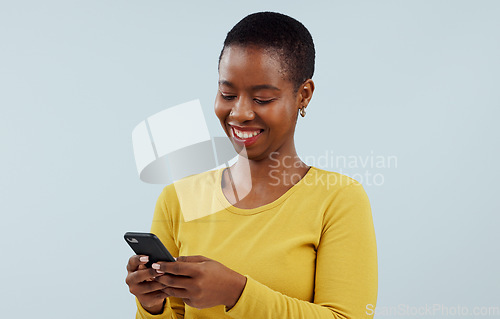 Image of Happy black woman, phone and communication for social media against a blue studio background. Face of African female person smile on mobile smartphone for online chatting, texting or search on mockup