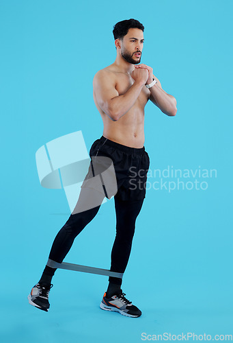 Image of Man, legs and resistance band in workout, training or fitness against a blue studio background. Male person, athlete or serious model with straps for cardio exercise, endurance or stamina on mockup